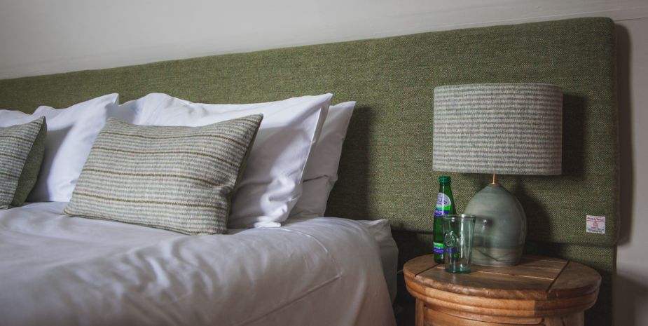 Galson Farm Guesthouse double bedroom detail with green decor, bed and sidetable.