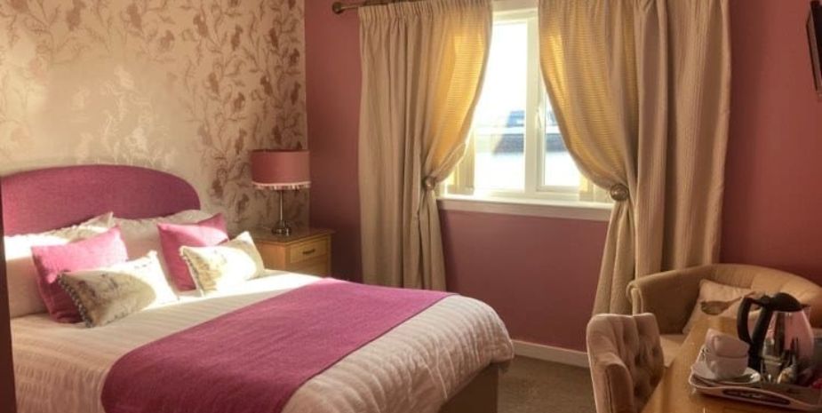 Twenty Seven B&B, Stornoway, bedroom with bed, side table and seating area.