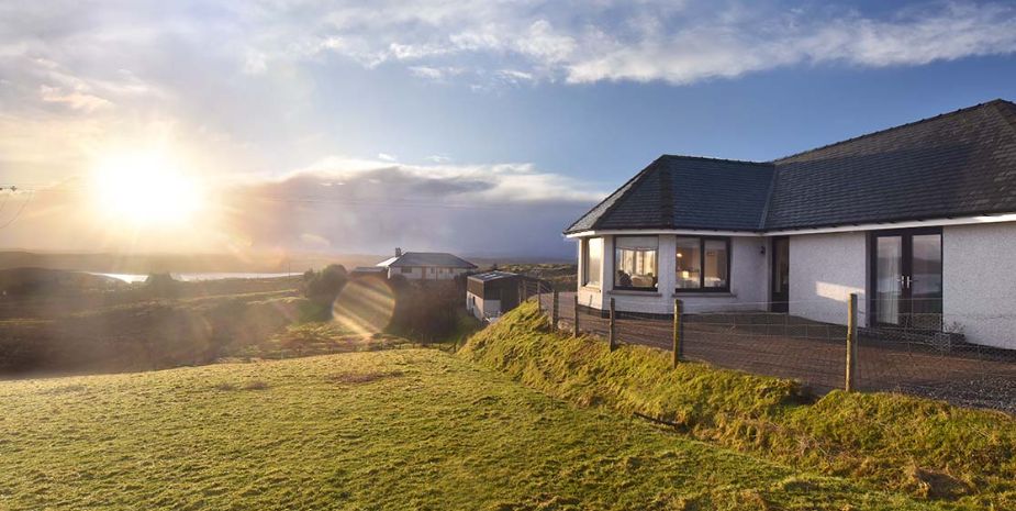 Sunlight casting a warm glow on Taigh Chailean in the countryside.
