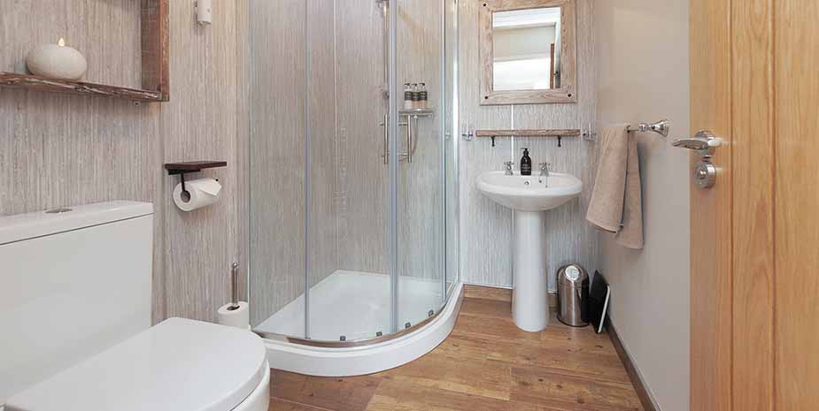 A bright bathroom with modern shower, toilet and sink in Seaview B&B on the Isle of Lewis.