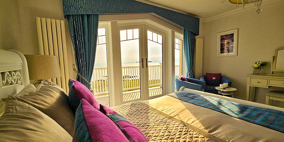 Spacious superking room in Sranndabhal B&B, showcasing a comfortable superking bed and a lovely balcony overlooking the sounds of Harris.